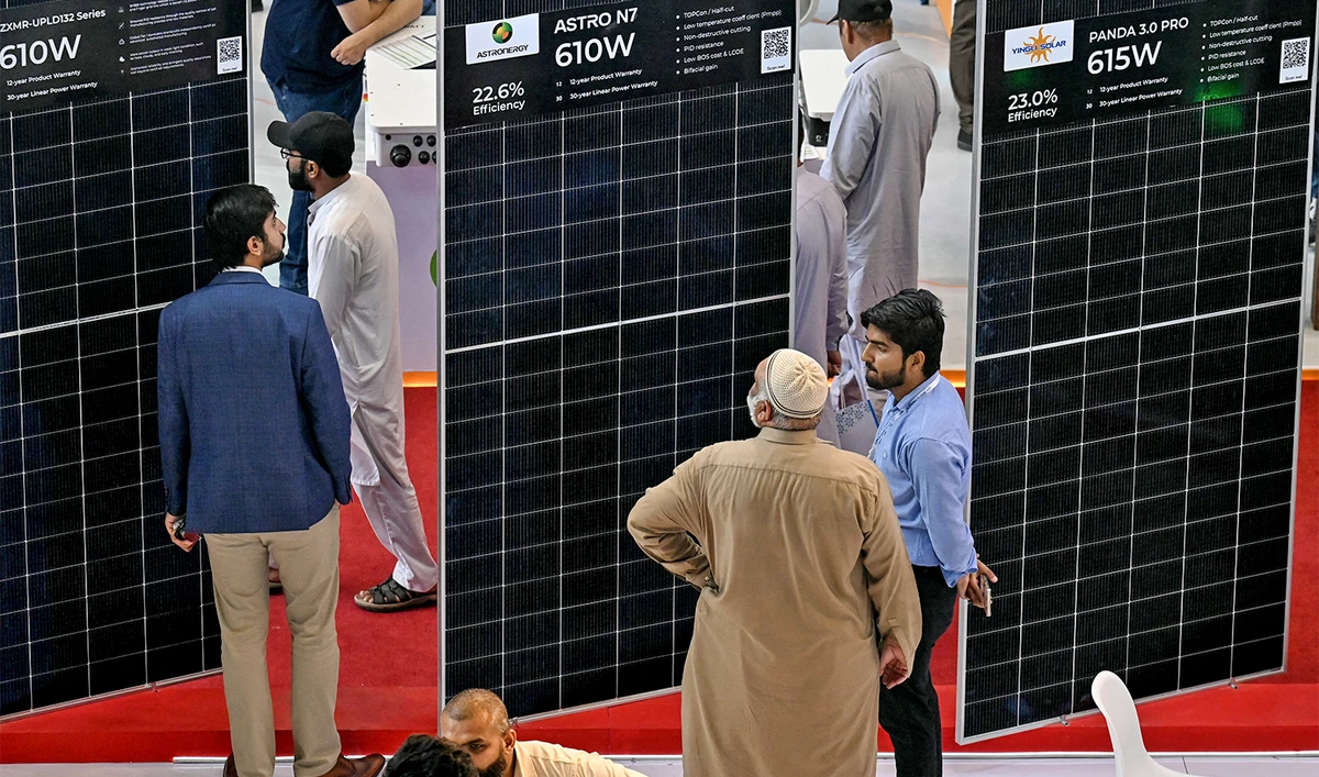 A visitor looks at solar panels exhibited during the International Solar Energy Meet (ISME) Pakistan in Lahore on May 24, 2025. (AFP/File)