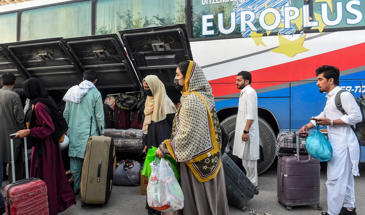 Pakistani citizens who were residing in Iran arrive with their belongings in Quetta on June 17, 2025, amid the ongoing conflict between Israel and Iran. (AFP)
