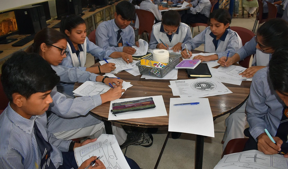 The picture shared on May 1, 2025 shows students coloring a work sheet at Sanjan Nagar Public Education Trust School in Lahore, Pakistan. (Sanjan Nagar Public Education Trust School)