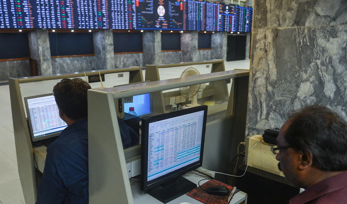 Brokers monitor the latests share prices at the Pakistan Stock Exchange in Karachi on February 14, 2023. (AFP/File)