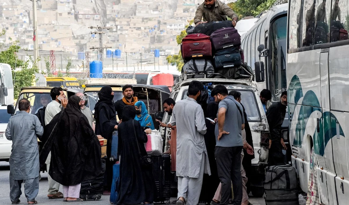 Pakistani nationals who were residing in Iran, arrive with their belongings in Quetta on June 22, 2025. (AFP)