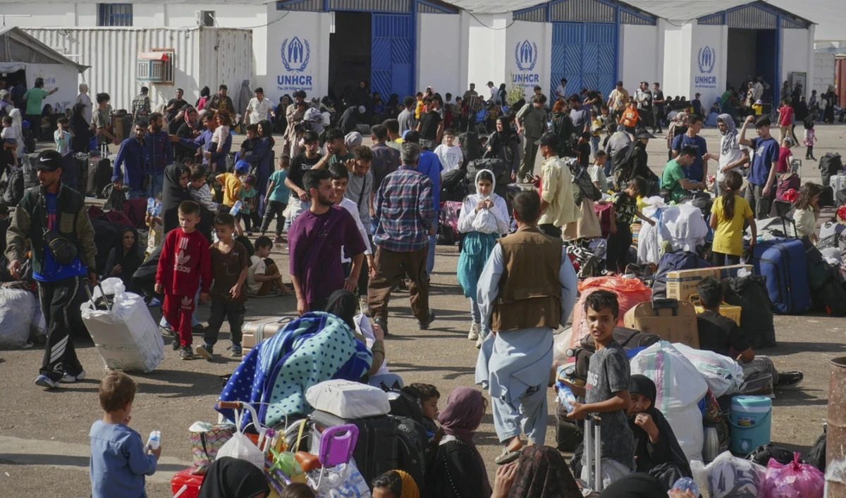 Afghan refugees who returned after fleeing Iran to escape deportation and conflict gather at a UNHCR facility near the Islam Qala crossing in western Herat province, Afghanistan on June 20, 2025. (AP)