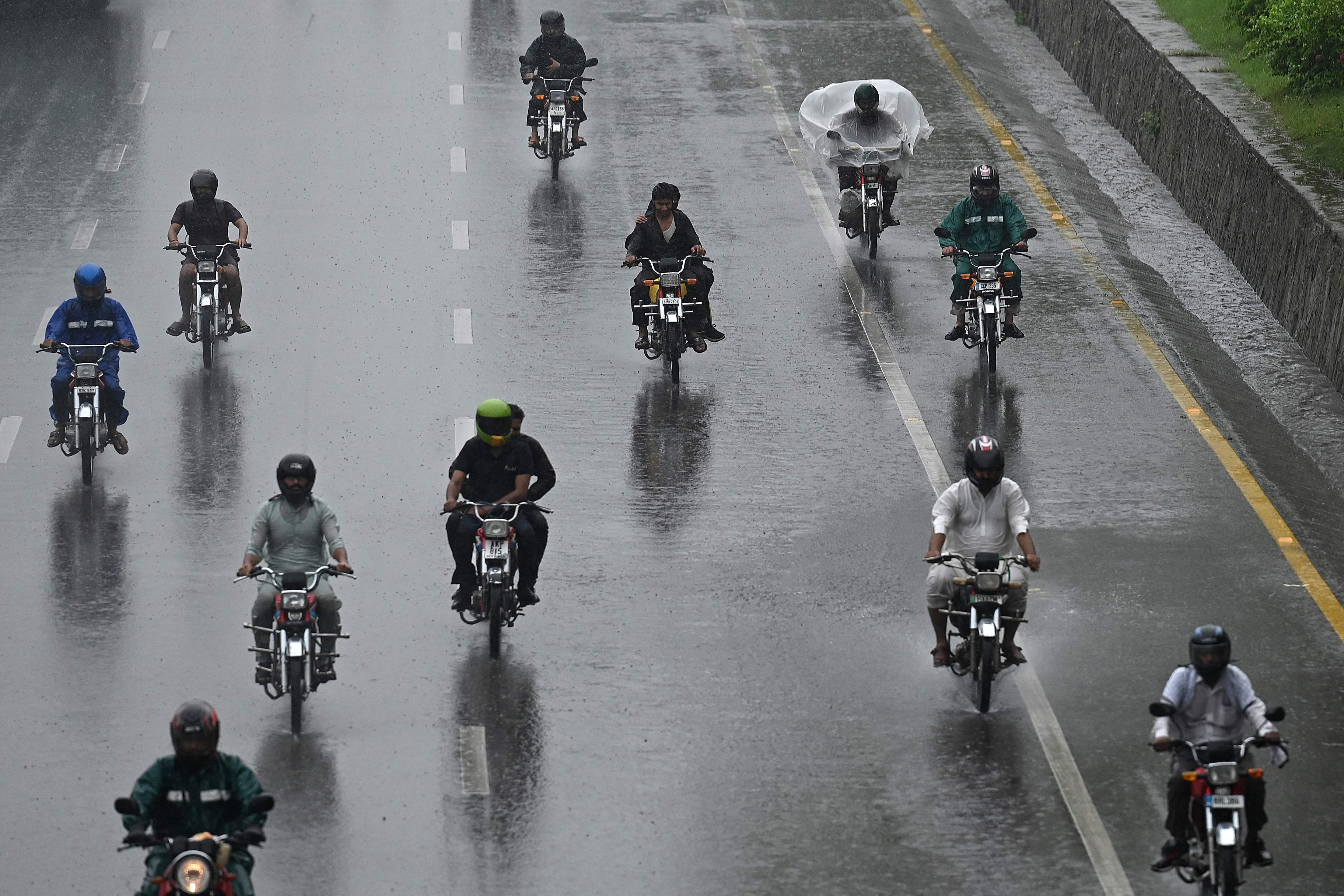Motorists make their way along a road as it rains in Islamabad, Pakistan, on June 26, 2025. (AFP/File)
