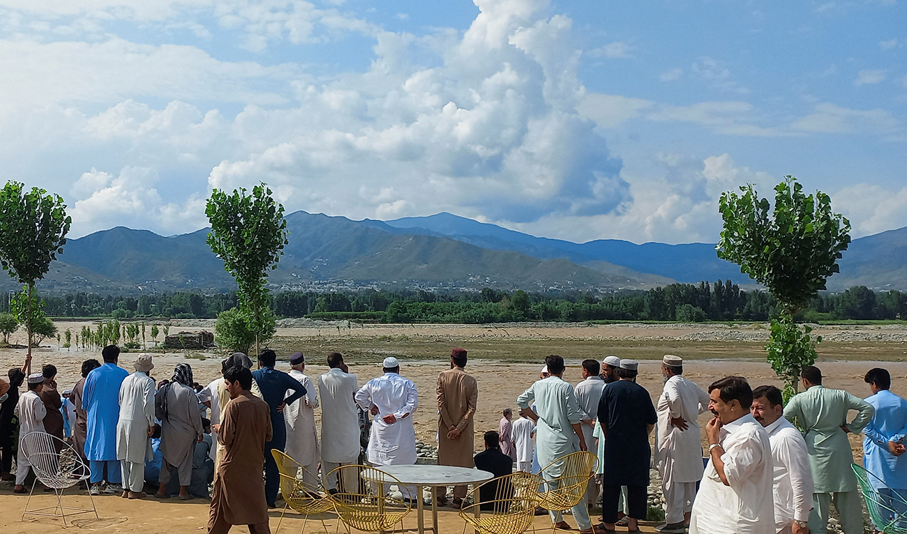 Residents gather, after tourists, who were on a picnic, were swept away by overflowing floodwaters in the Swat River, in Swat Valley in Pakistan on June 27, 2025. (REUTERS)