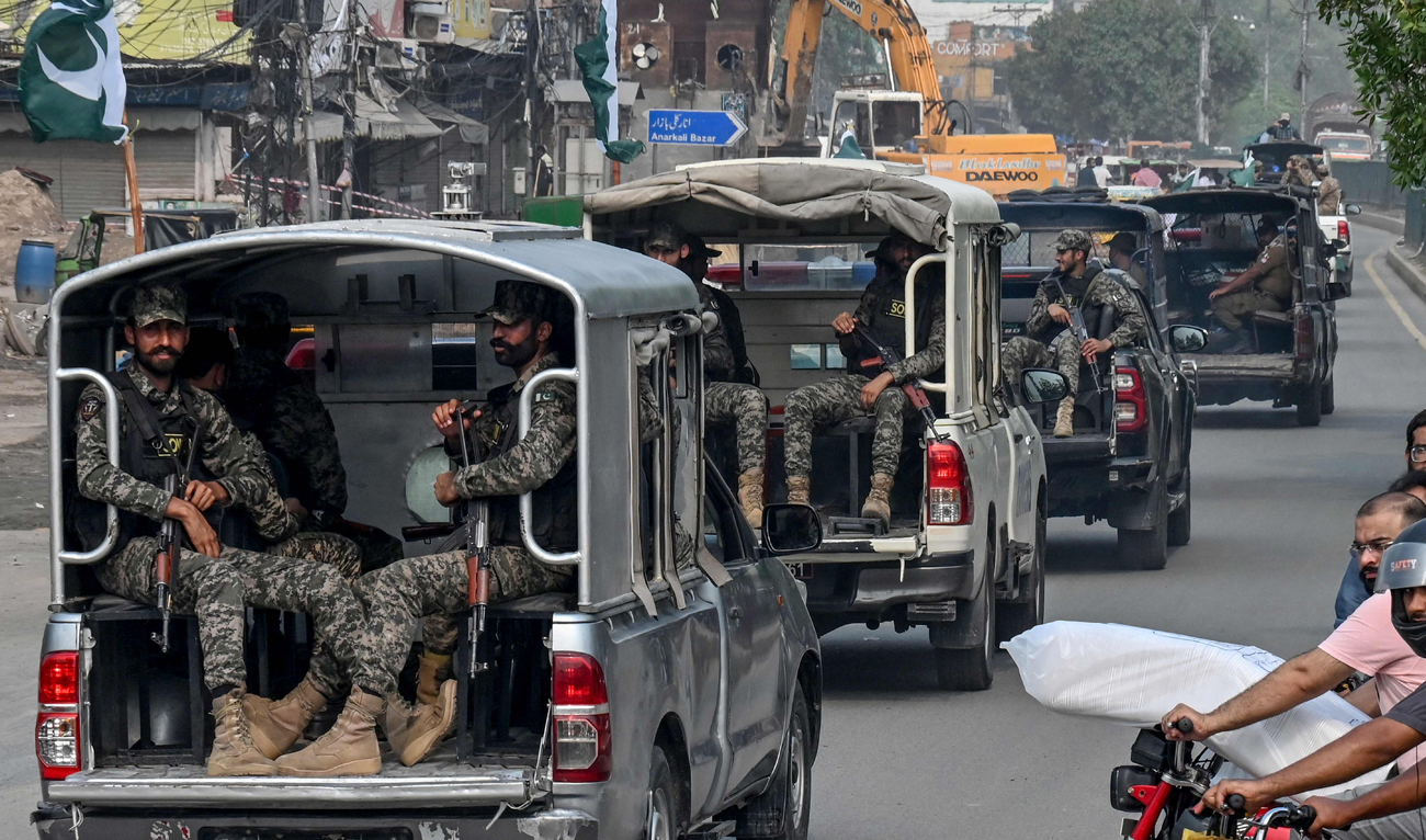 Security personnel patrol along a street in Lahore on July 4, 2025. (AFP)