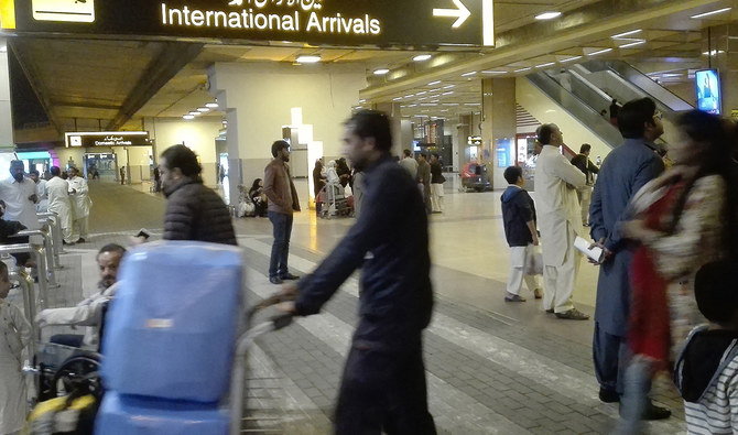 Passengers walk after their arrival at the Jinnah International Airport in Karachi, Pakistan, on January 31, 2020. (AFP/File)