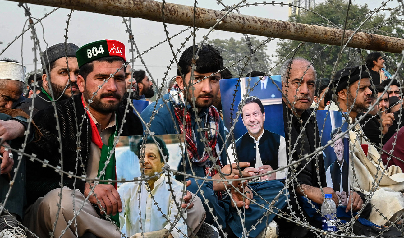 Supporters of jailed former prime minister Imran Khan hold his posters during a gathering by the Pakistan Tehreek-e-Insaf (PTI) party to observe Martyrs' Day to honour those who allegedly died during last month's protest, in Peshawar on December 15, 2024. (AFP/File)