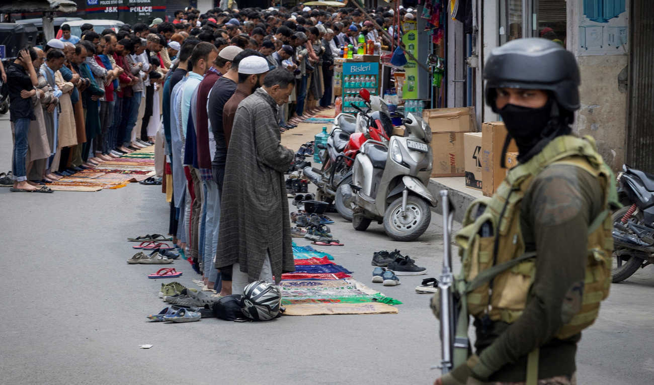 Kashmiri Muslims offer Friday prayers on a road as a security personnel stands guard, in Srinagar on May 2, 2025. (REUTERS/File)