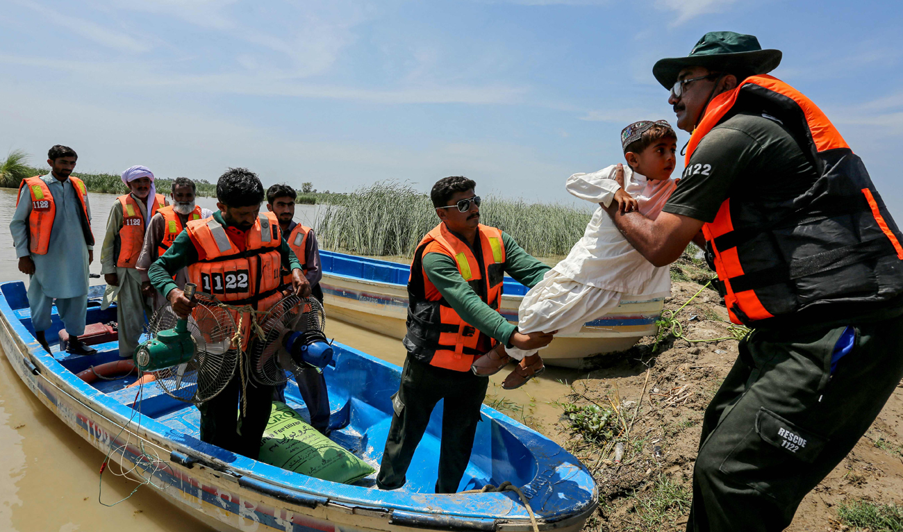 Rescue personnel shift villagers to a safer place by boat from a flooded village following heavy rains in the Taunsa district of Punjab province on July 16, 2025. (AFP)