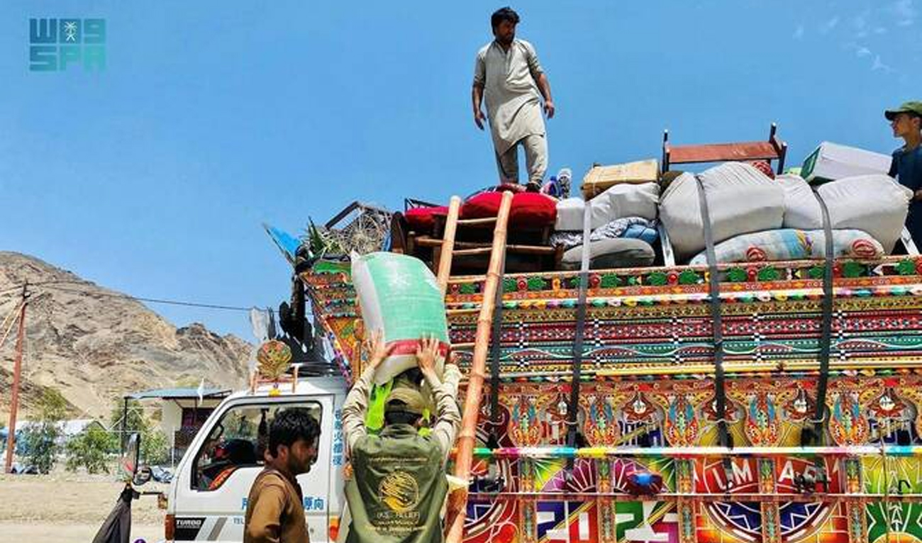 The handout photograph released on July 20, 2025, shows a man unloading a food bag at the Omari camp near the Torkham border crossing in Afghanistan. (SPA)