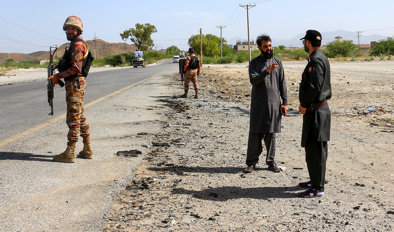 Security personnel stand guard at the site of a school bus bombing in Khuzdar district of Balochistan province on May 21, 2025. (AFP/File)