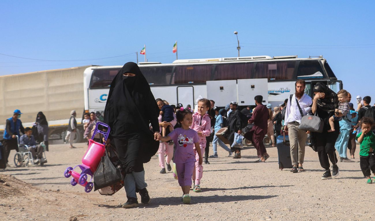 An Iranian bus drops off Afghan refugees at Zero Point on the Islam Qala border in Herat Province on July 24, 2025. (AFP)