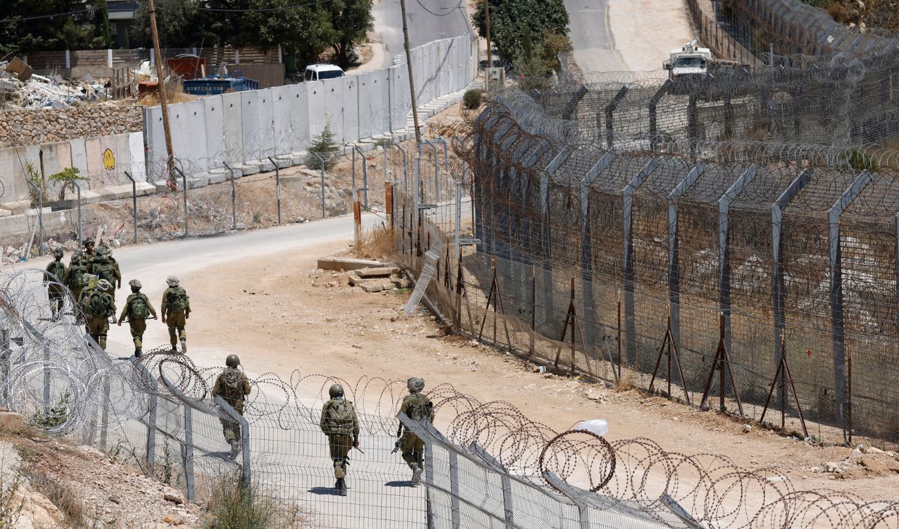 Israeli troops patrol the border fence with Syria near the Druze village of Majdal Shams in the Israel-annexed Golan Heights on July 23, 2025. (AFP)