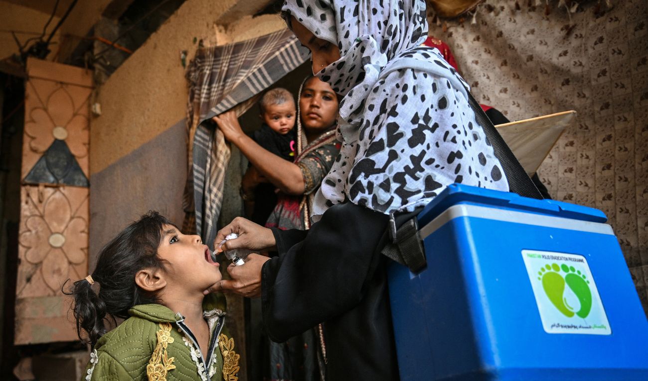 A health worker (R) administers polio drops to a child on the first day of a nationwide polio vaccination campaign, in Karachi on February 3, 2025. (AFP/ file)