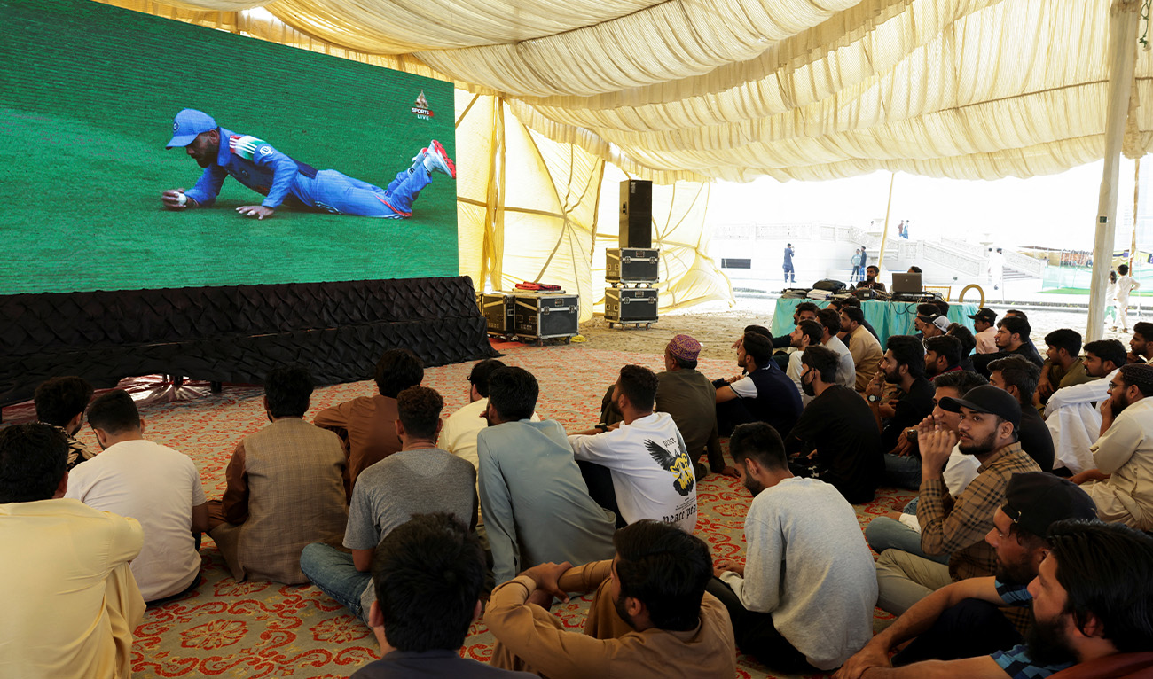 Pakistani cricket fans watch a match between India and Pakistan on a big screen, during the ICC Men's Champions Trophy, in Karachi, Pakistan, February 23, 2025. (Reuters/File)