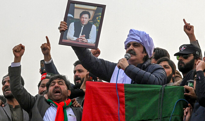 Khyber Pakhtunkhwa Chief Minister Ali Amin Gandapur (third right) holds a portrait of Pakistan's former prime minister Imran Khan, during a protest against the alleged skewing in Pakistan's national election results, in Peshawar on February 17, 2024. (AFP/File)