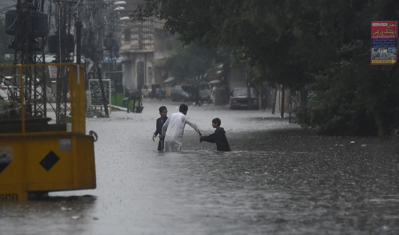 People wade through the flooded street after during the monssoon rain in Rawalpindi, Pakistan on July 17, 2025. (REUTERS/File)