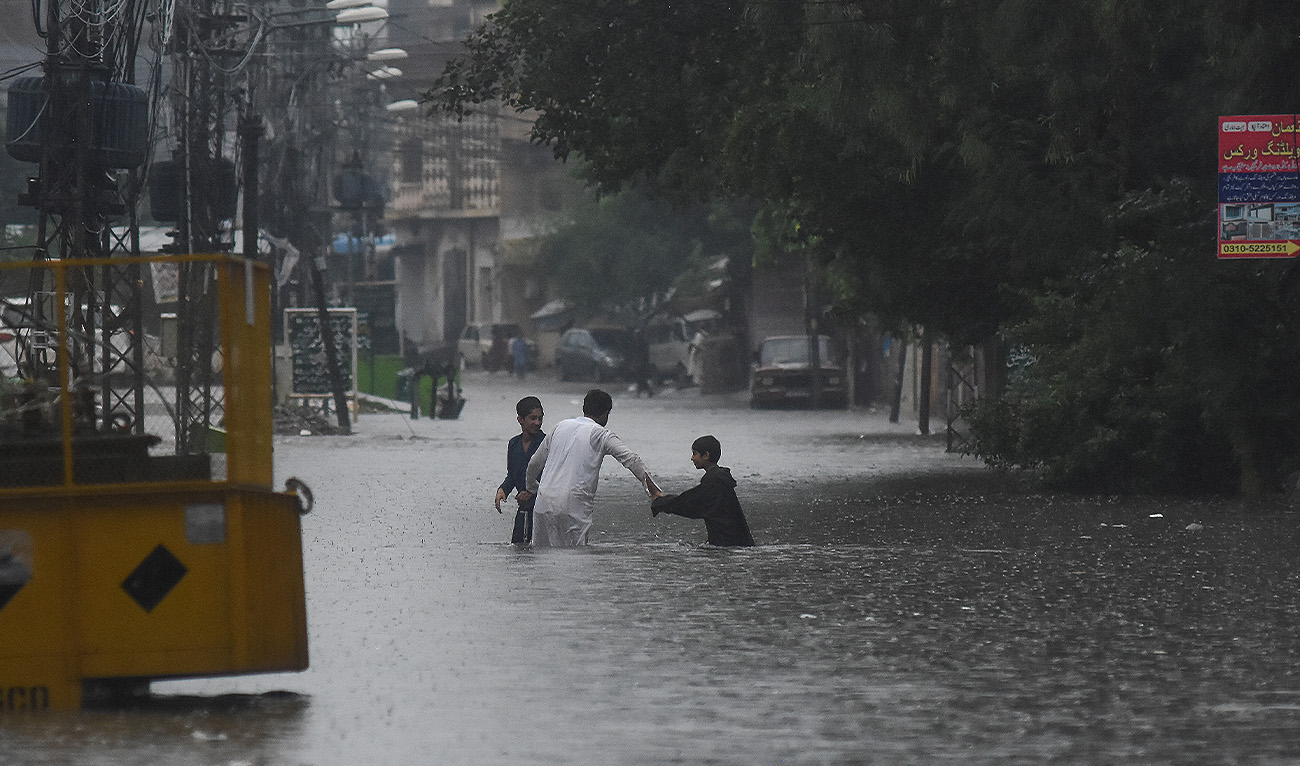 People wade through the flooded street after during the monssoon rain in Rawalpindi, Pakistan on July 17, 2025. (Reuters/File)