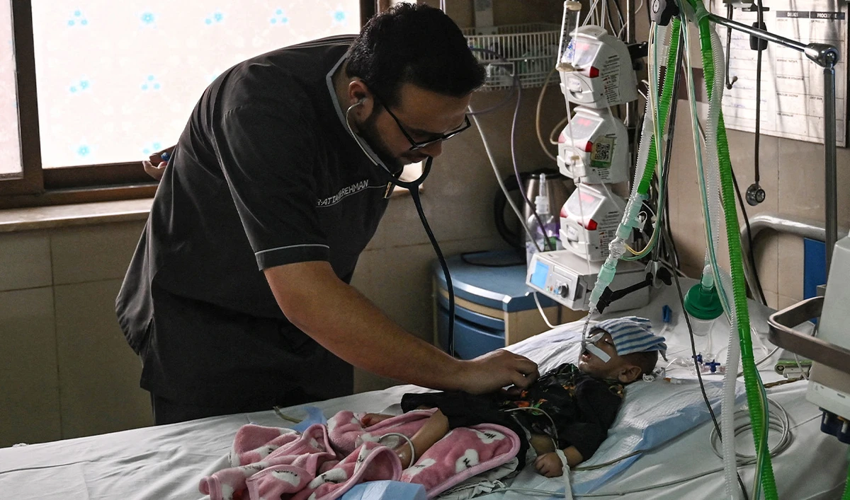 A doctor treats a child suffering from pneumonia, at the ICU ward of the Children's Hospital in Lahore on January 31, 2024. (AFP/File)