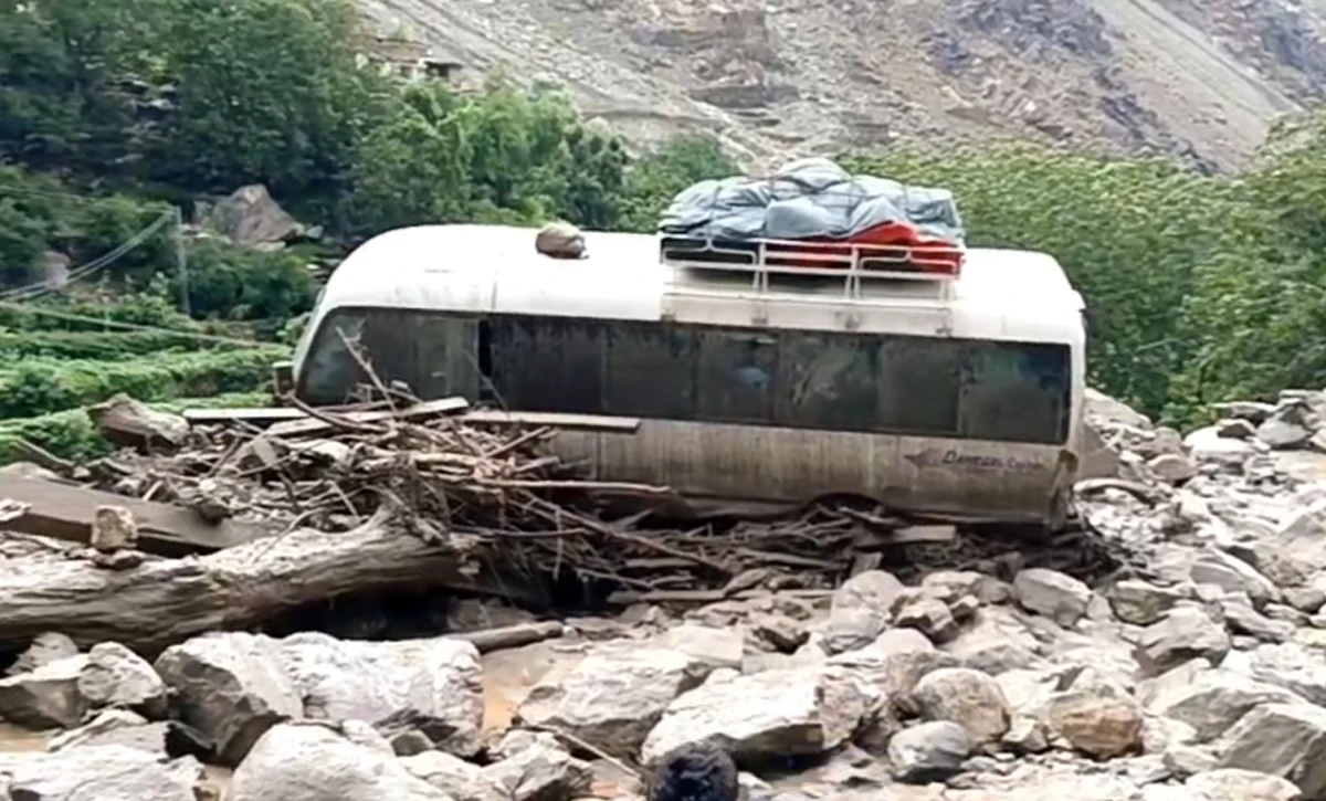 The screengrab taken from a video shows a bus being hit by a flash flood on Babusar Road in Pakistan’s northern Gilgit-Baltistan region on July 21, 2025. (Screengrab/NDMA)