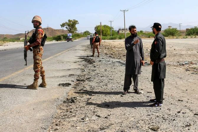 Security personnel stand guard at the site of a school bus bombing in Khuzdar district of Balochistan province on May 21, 2025. (AFP/File)