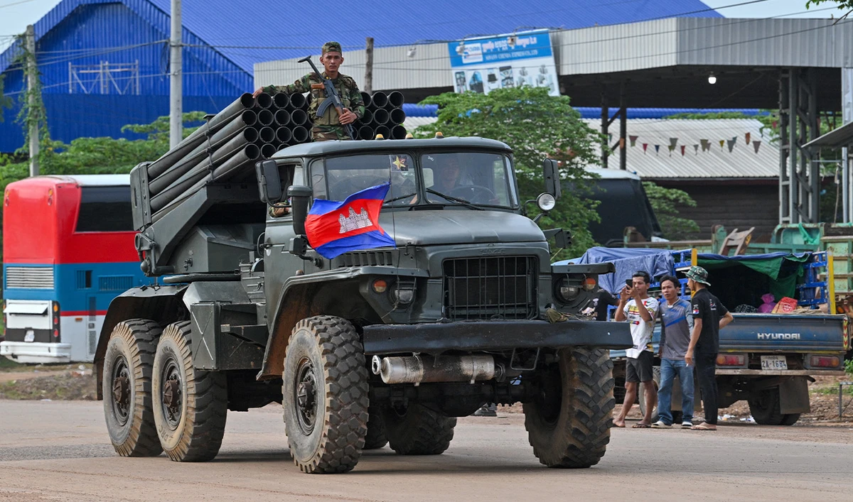 A Cambodian soldier stands on a truck carrying a Russian-made BM-21 rocket launcher travelling along a street in Oddar Meanchey province on July 25, 2025. (AFP)