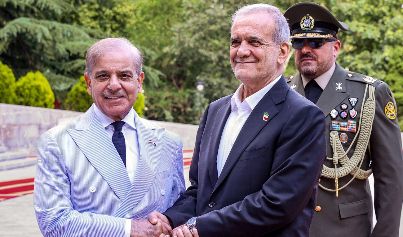 This handout picture provided by the Iranian presidency shows Iran's President Masoud Pezeshkian (R) receiving Pakistan's Prime minister Shehbaz Sharif (L) in Tehran on May 26, 2025.