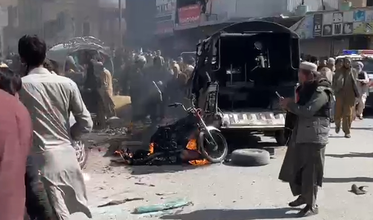People gather near a police van targeted in a militant attack in Quetta, Balochistan on March 27, 2025. (AN photo/File)