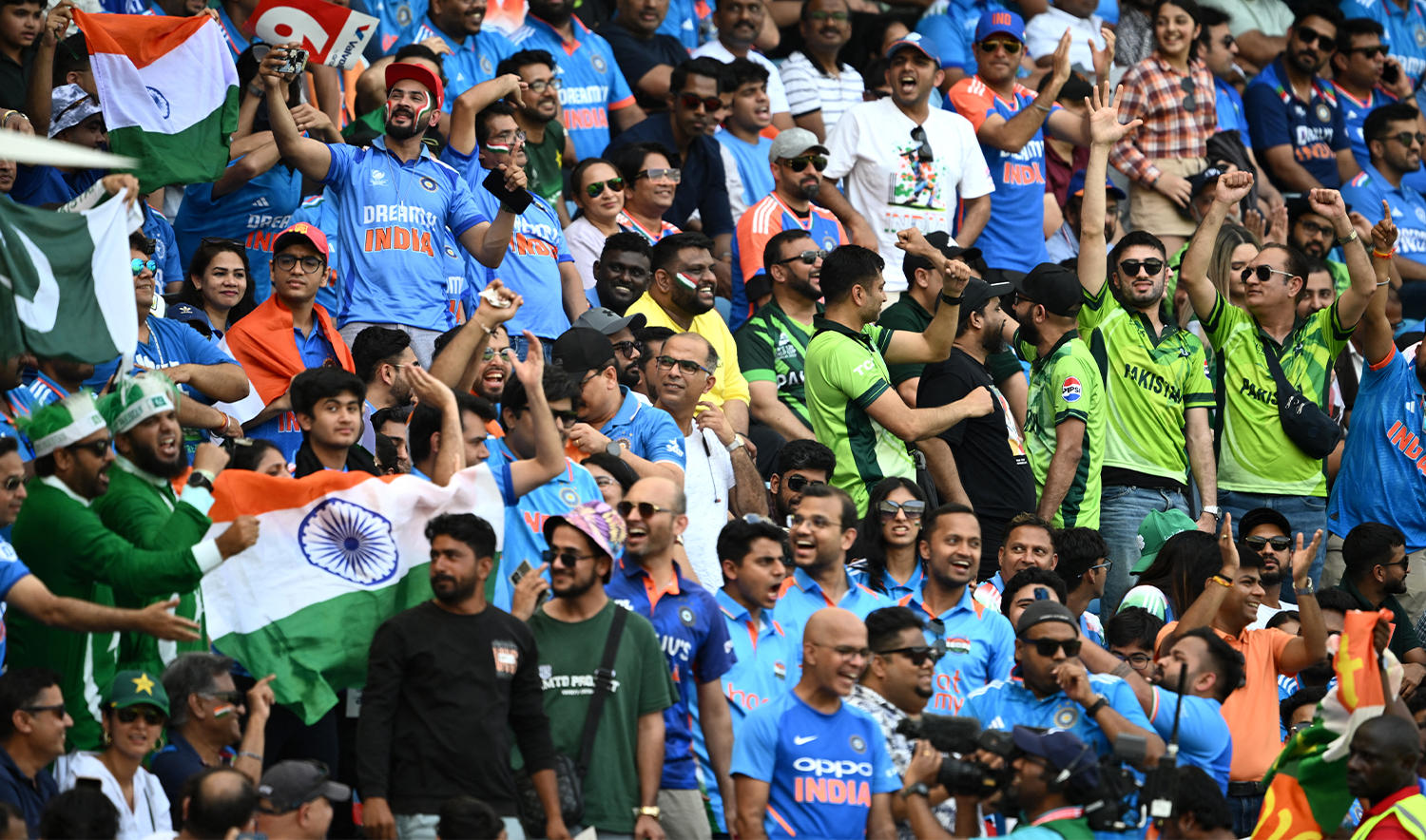 Fans cheer during the ICC Champions Trophy one-day international (ODI) cricket match between Pakistan and India at the Dubai International Stadium in Dubai on February 23, 2025. (AFP)