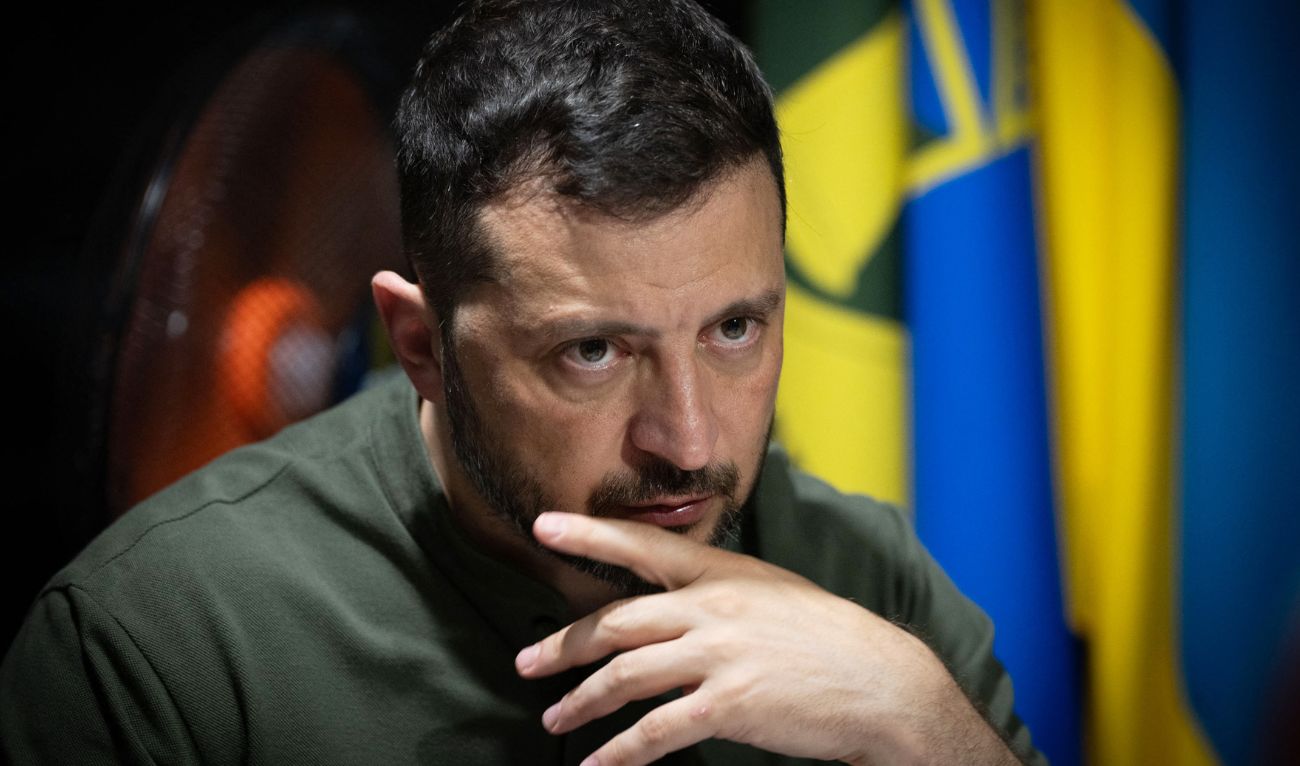 In this handout photograph taken and released by the Ukrainian Presidential Press Service on August 4, 2025, Ukraine's President Volodymyr Zelensky looks on as he meets with soldiers of the 57th Separate Motorised Infantry Brigade on the frontline positions at an undisclosed location in the Kharkiv region, amid the Russian invasion of Ukraine. (AFP)