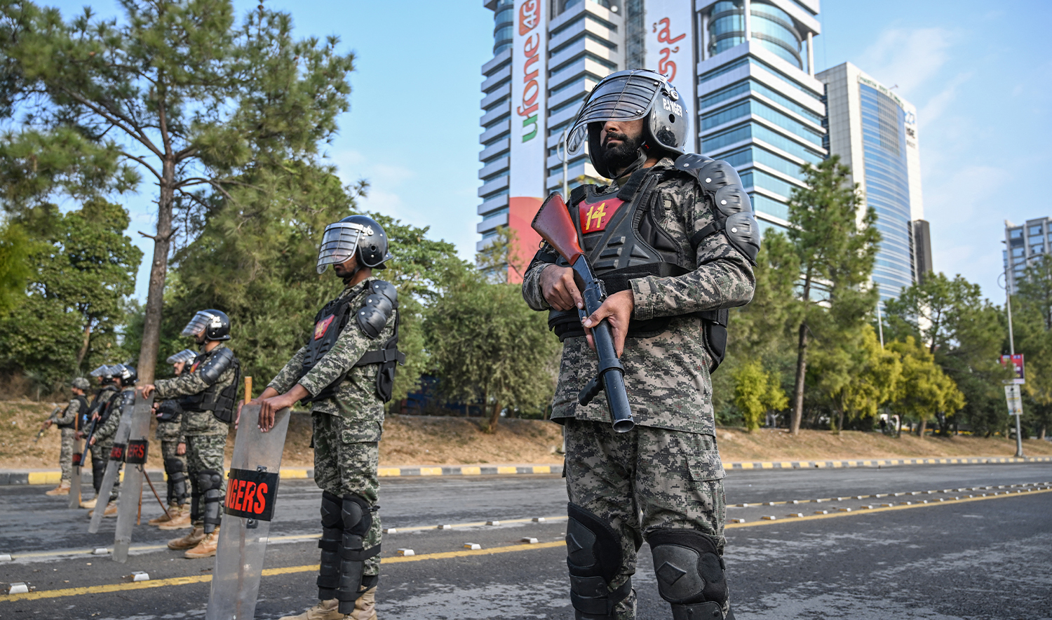 Paramilitary soldiers stand guard at a blocked road leading towards the Red Zone area ahead of a protest rally by jailed former prime minister Imran Khan's Pakistan Tehreek-e-Insaf (PTI) party in Islamabad on November 24, 2024. (AFP/File)