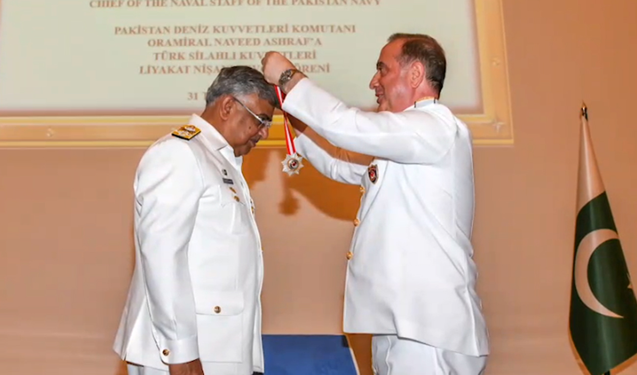 Pakistan's Navy Chief Admiral Naveed Ashraf, left, being award Turkish military honor "Legion of Merit" in Ankara, Turkey, in a picture released by Pakistan Navy on August 5, 2025.