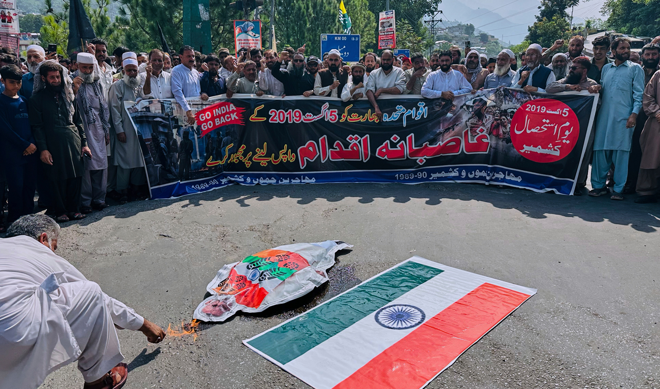 Members of a civil society ‘Muhajjireen Jammu and Kashmir’ burn a portrait of Indian Prime Minister Narendra Modi and representation of an Indian flag in Muzaffarabad, Pakistan, Tuesday, August 5, 2025, during a rally to mark the sixth anniversary of India’s revocation of the disputed region’s semi-autonomous status. (AP)