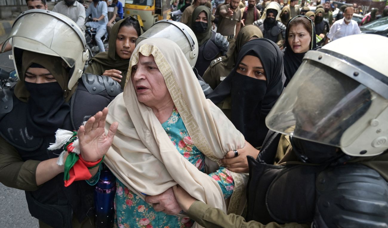 Police detain a member of Pakistan Tehreek-e-Insaf (PTI) party during a protest demanding the release of jailed former Prime Minister Imran Khan, outside the Provincial Assembly in Lahore on August 5, 2025. (AFP)