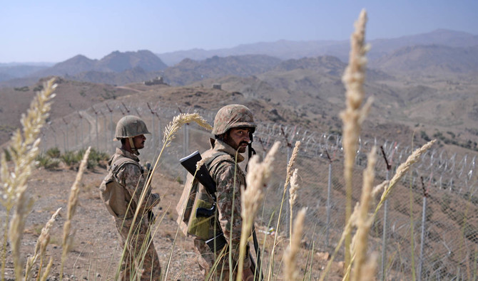 In this file photo, Pakistani soldiers keep vigil next to a border fencing along Afghan border at Kitton Orchard Post in Pakistan’s North Waziristan tribal agency on Oct. 18, 2017. (AFP)