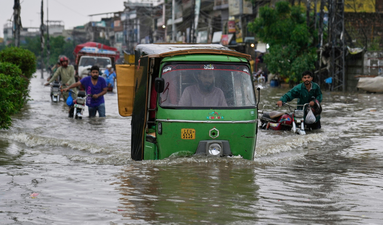 Motorists drive through a flooded road caused by heavy monsoon rain in Lahore, Pakistan on July 23, 2025. (AP/File)