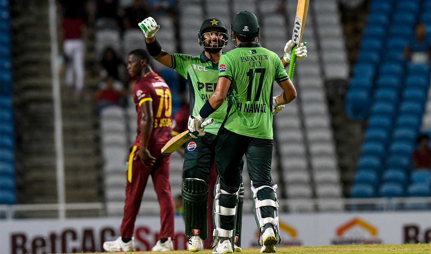 Hussain Talat (L) and Hasan Nawaz (R) of Pakistan celebrate winning the first One Day International (ODI) cricket match between West Indies and Pakistan at Brian Lara Cricket Academy in Tarouba, San Fernando, Trinidad and Tobago on August 8, 2025. (AFP)