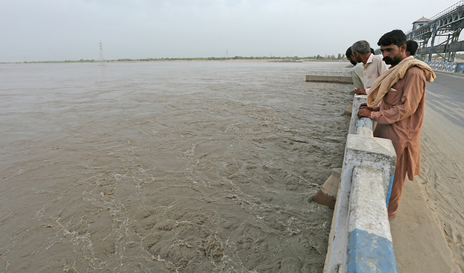 Commuters watch overflowing River Sutlej at Islam Headworks in Hasilpur, in Punjab province on August 26, 2023. (AFP/File)