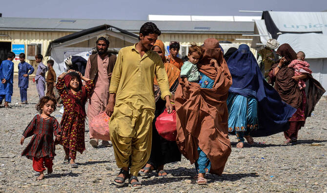 Afghan refugees carrying their belongings arrive from Pakistan at a registration center in Takhta Pul district of Kandahar province on April 13, 2025. (AFP)