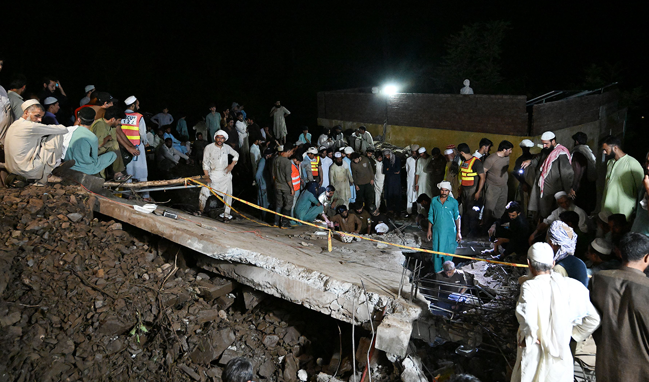Rescue workers and residents search for victims in the debris of collapsed houses after a cloudburst in Dolari village, Swabi district, in northern Pakistan's mountainous Khyber Pakhtunkhwa province, on August 18, 2025. (AFP)