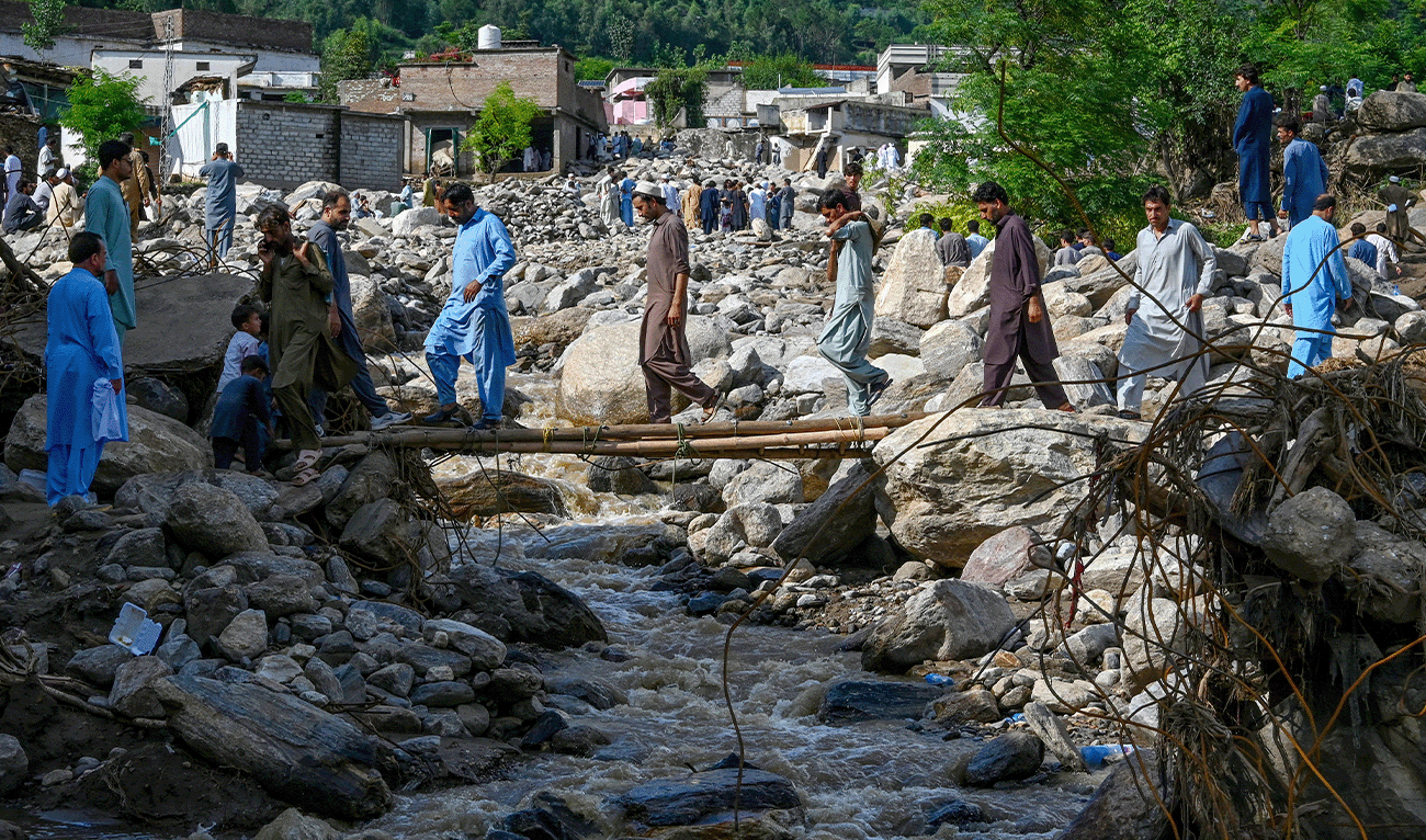 People cross a makeshift bridge at the flood-affected Buner district in Pakistan's mountainous Khyber Pakhtunkhwa province on August 19, 2025. (AFP)