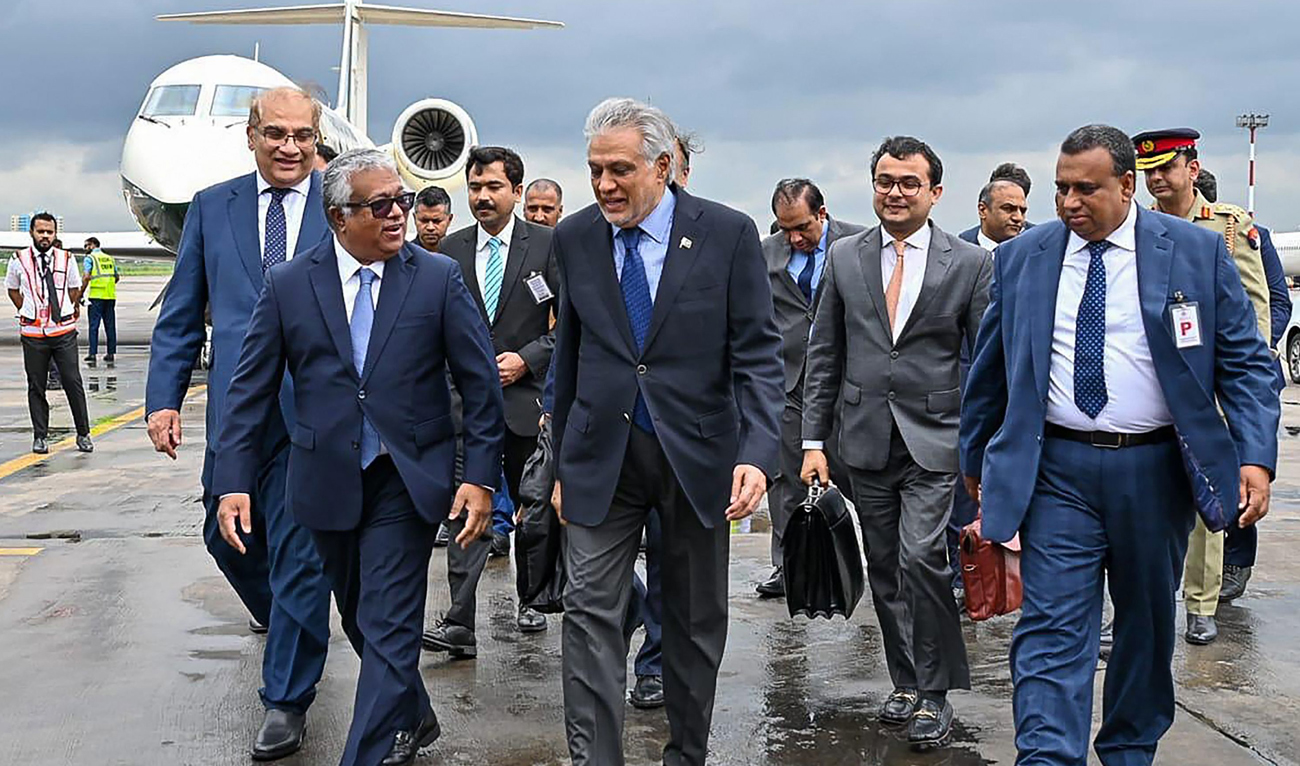 This handout photograph taken and released by Bangladesh's Ministry of Foreign Affairs on August 23, 2025 shows Bangladesh's Foreign Secretary Asad Alam Siam (L) receiving Ishaq Dar (2L), Pakistan's Foreign Minister, at the Hazrat Shahjalal International Airport in Dhaka. (AFP)