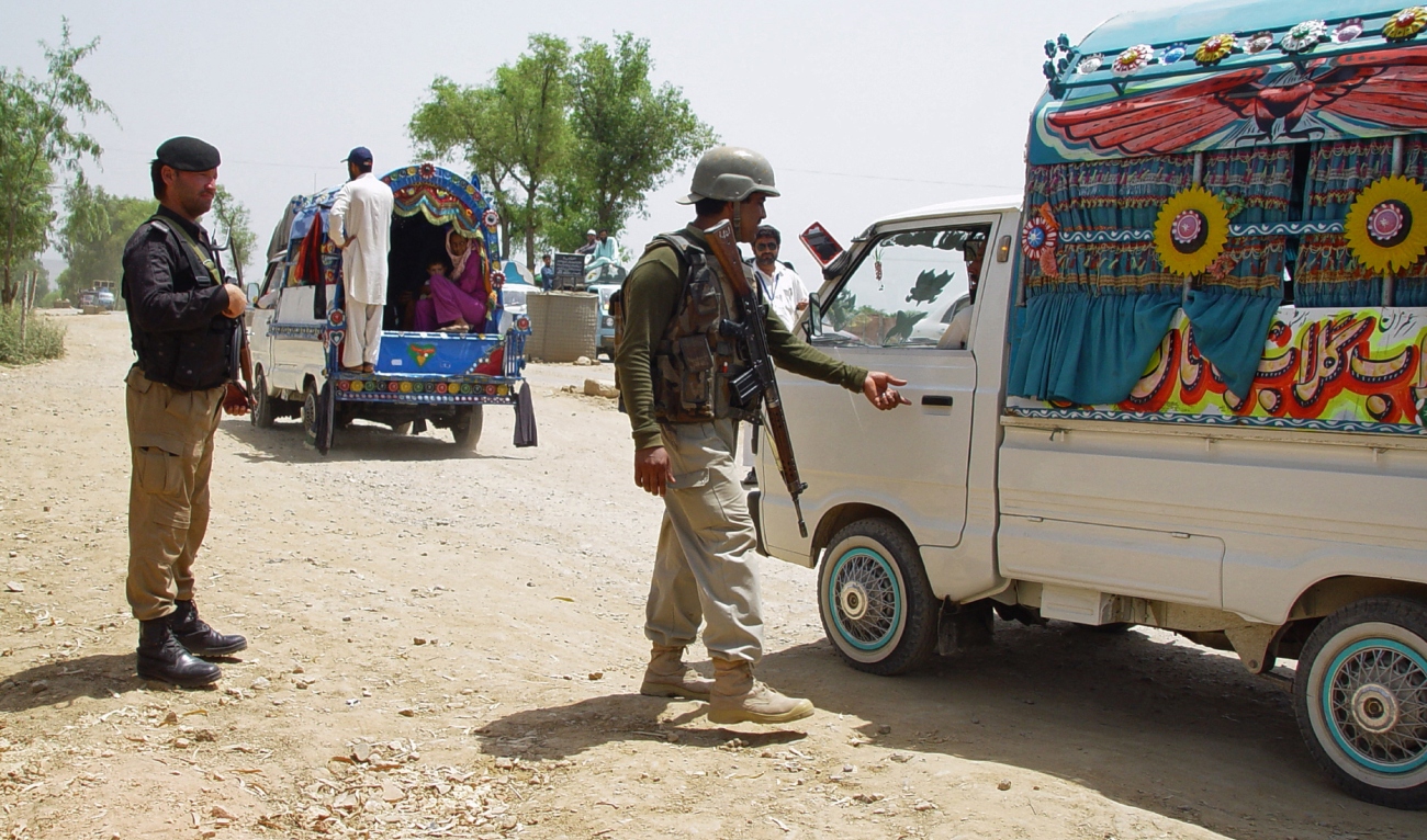 A Pakistani paramilitary solder checks a passenger van at a checkpoint in Hangu, a town in the Khyber Pakhtunkhwa province, on June 17, 2014. (AFP/File)