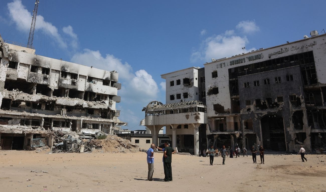 People stand in the compound of the destroyed al-Shifa hospital in Gaza City on August 26, 2025. (AFP)