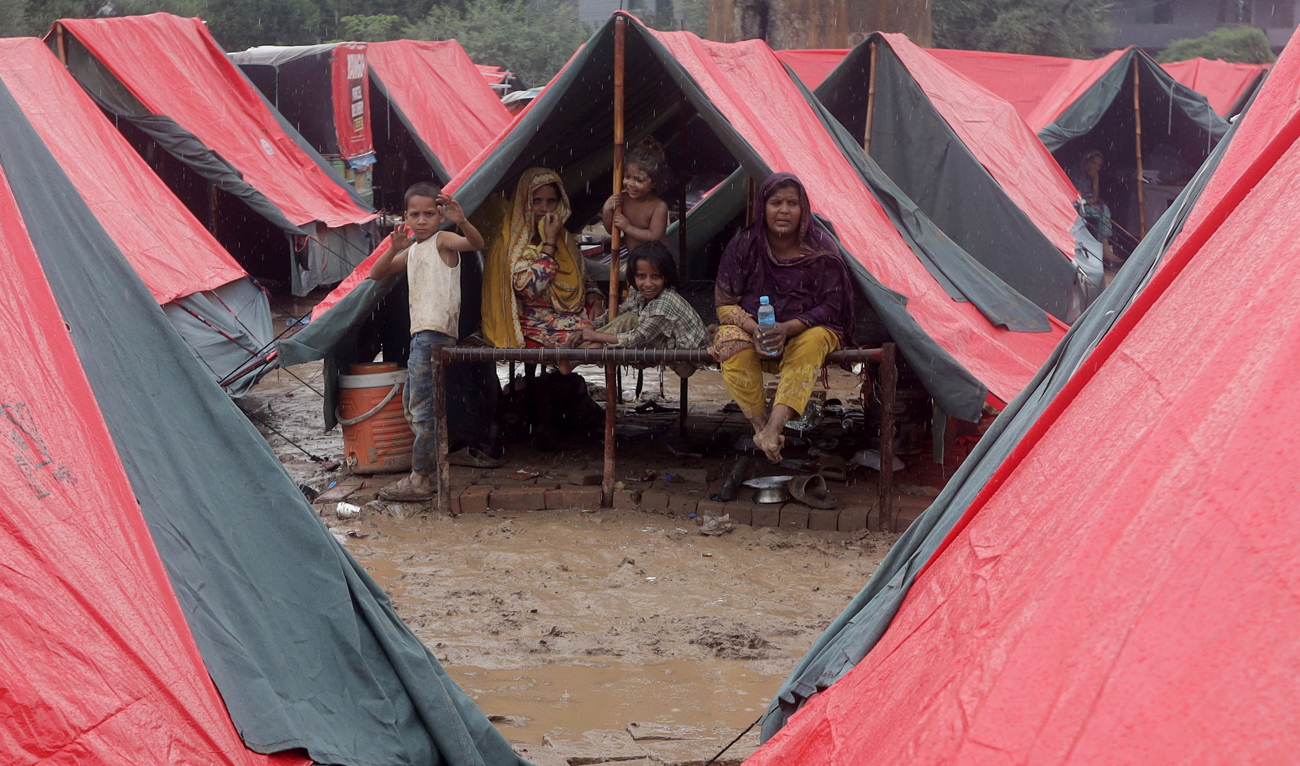 Members of a family, who fled from flooded banks of Ravi River, take shelter in a tent at a relief camp in Lahore, Pakistan on August 31, 2025. (REUTERS)