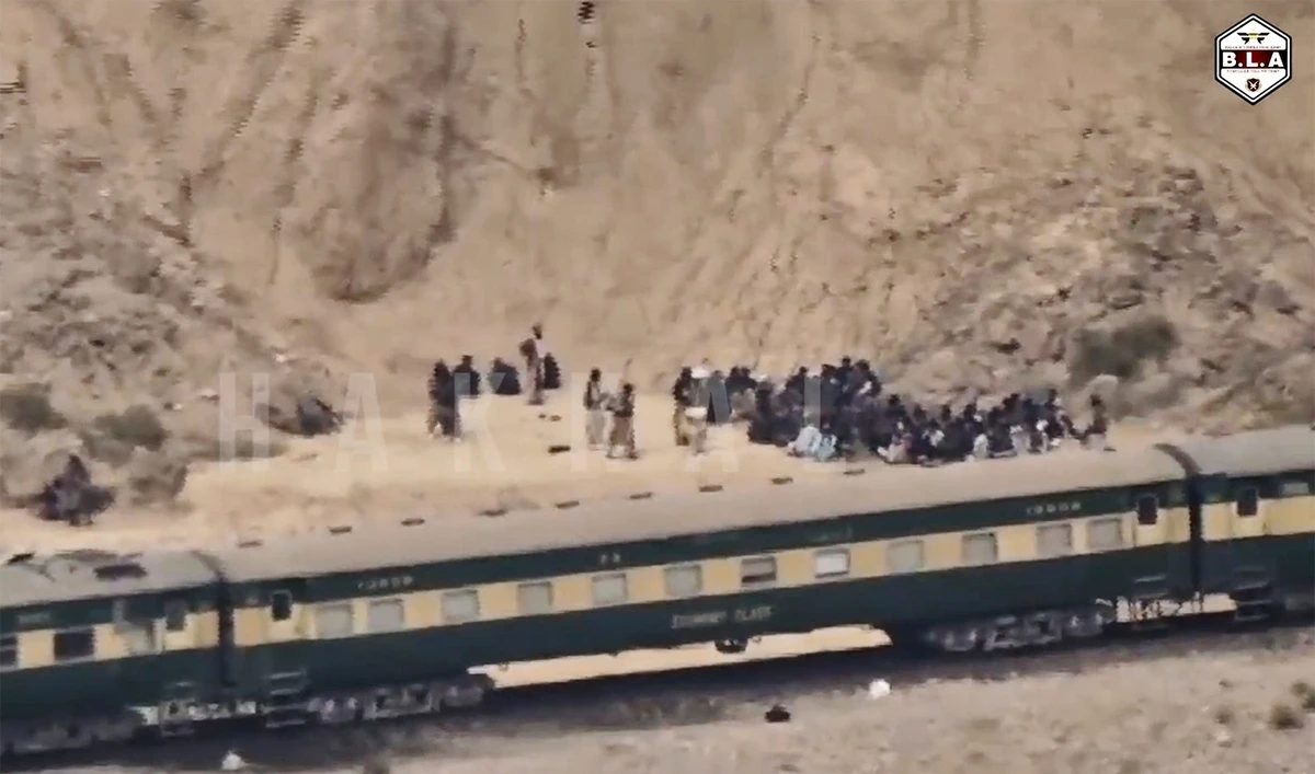 In this frame grab from a video released by the Balochistan Liberation Army shows people outside the a train after being attacked by BLA on its transit from Quetta to the northern city of Peshawar, in Bolan district of Pakistan's southwestern Balochistan province on March 12, 2025. (BLA via AP/ File)