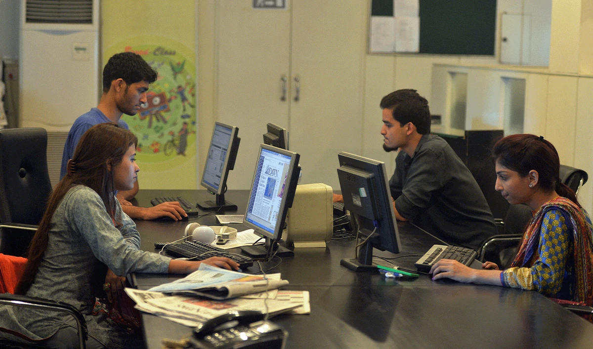 In this photograph taken on July 26, 2016, Pakistani staff of Islamabad-based Power 99 FM radio work on their computers at the radio station's office in Islamabad. (AFP/File)
