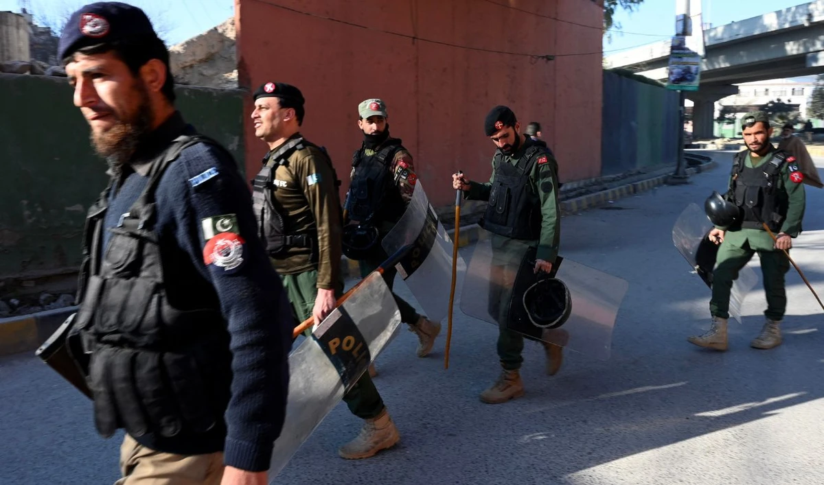 Police patrol along the street in Peshawar on February 9, 2024, a day after Pakistan's national elections. (AFP)
