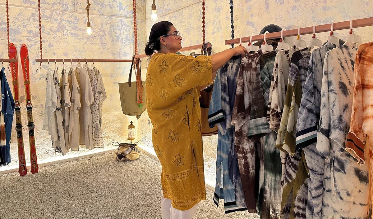 Sana Khan, founder of sustainable fashion brand Dhundli Zameen and Earthy Murkey working at her store in Islamabad on August 11, 2025. (AN Photo)