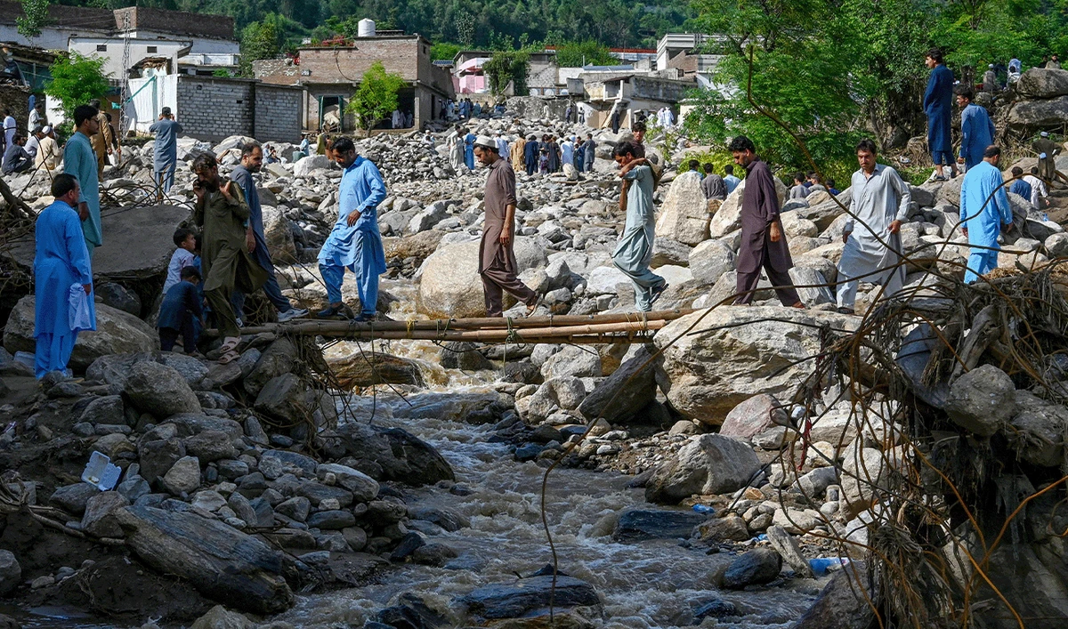 People cross a makeshift bridge at the flood-affected Buner district in Pakistan's mountainous Khyber Pakhtunkhwa province on August 19, 2025. (AFP)